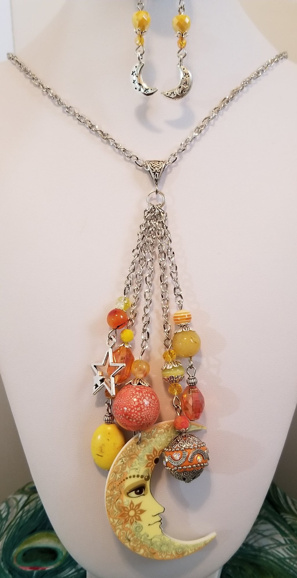 26 inch  yellow and orange necklace with five strands of  beads  and charms hanging from  middle